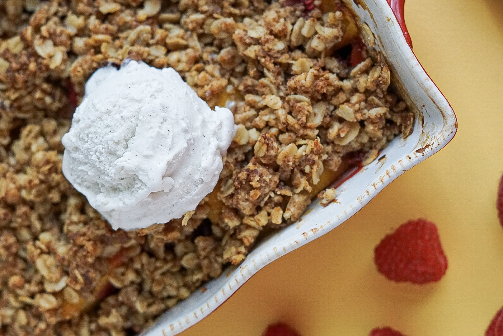 peach crumble in a red baking dish