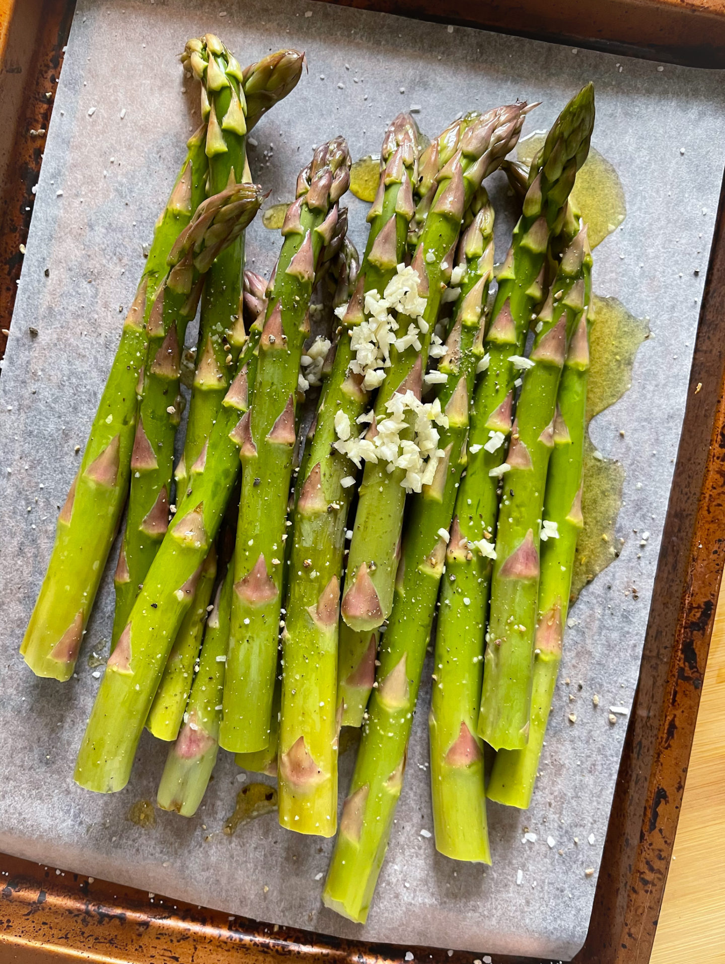 adding garlic to the asparagus
