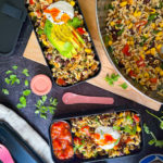rice salad with black beans and corn in a black bento box