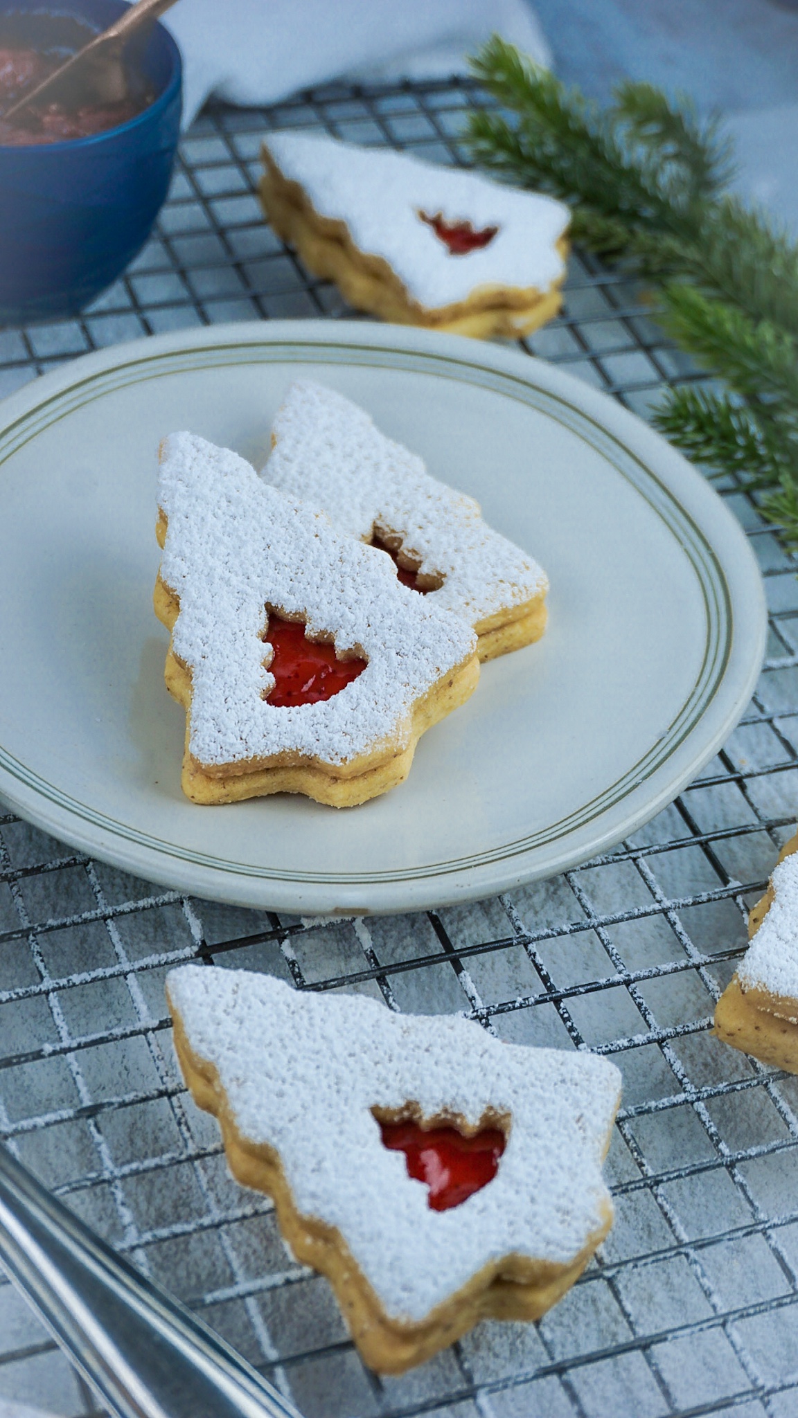 vegan sugar cookies with strawberry jam and powdered sugar