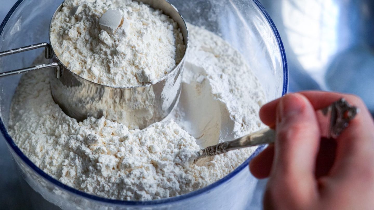 measuring flour in a measuring cup