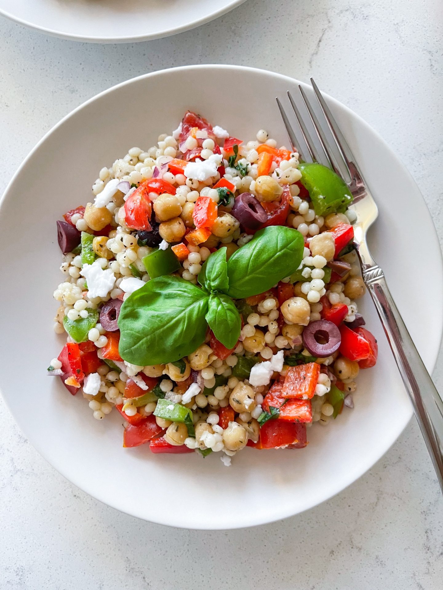 pearl couscous, bell peppers, onions, tomatoes, olives and lemon dressing