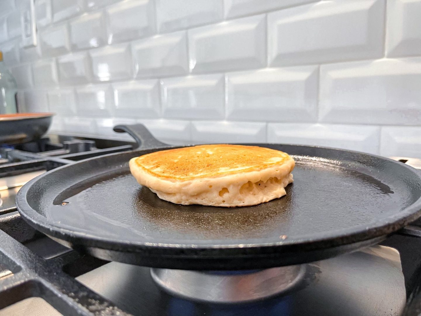 pancake cooking in a cast iron skillet