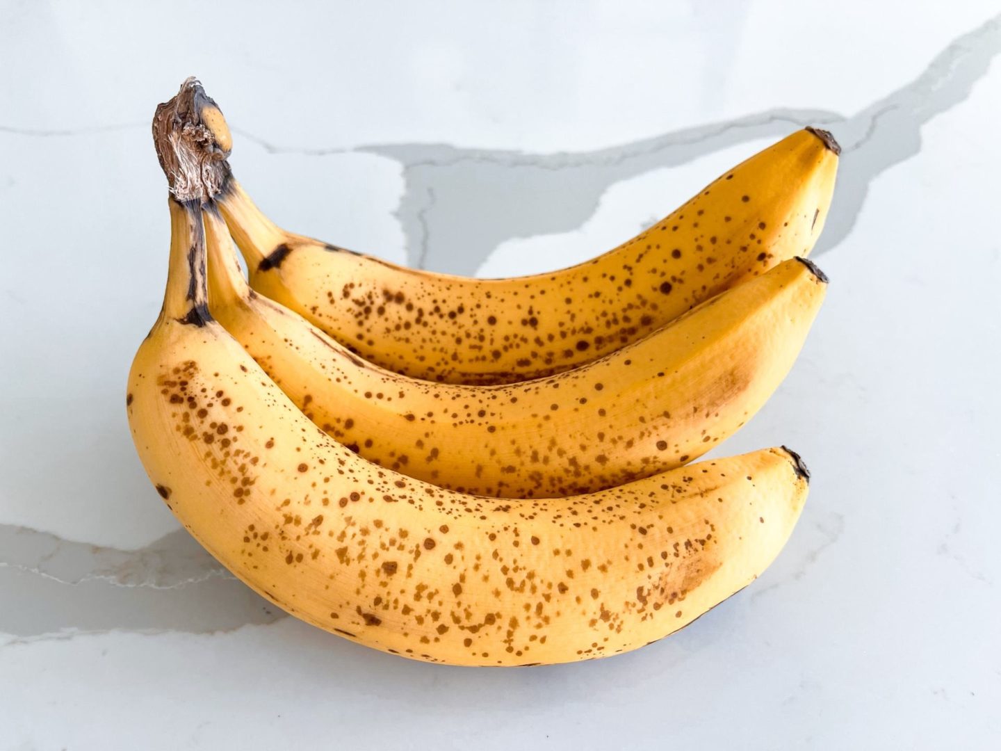 ripe bananas on a white marble countertop
