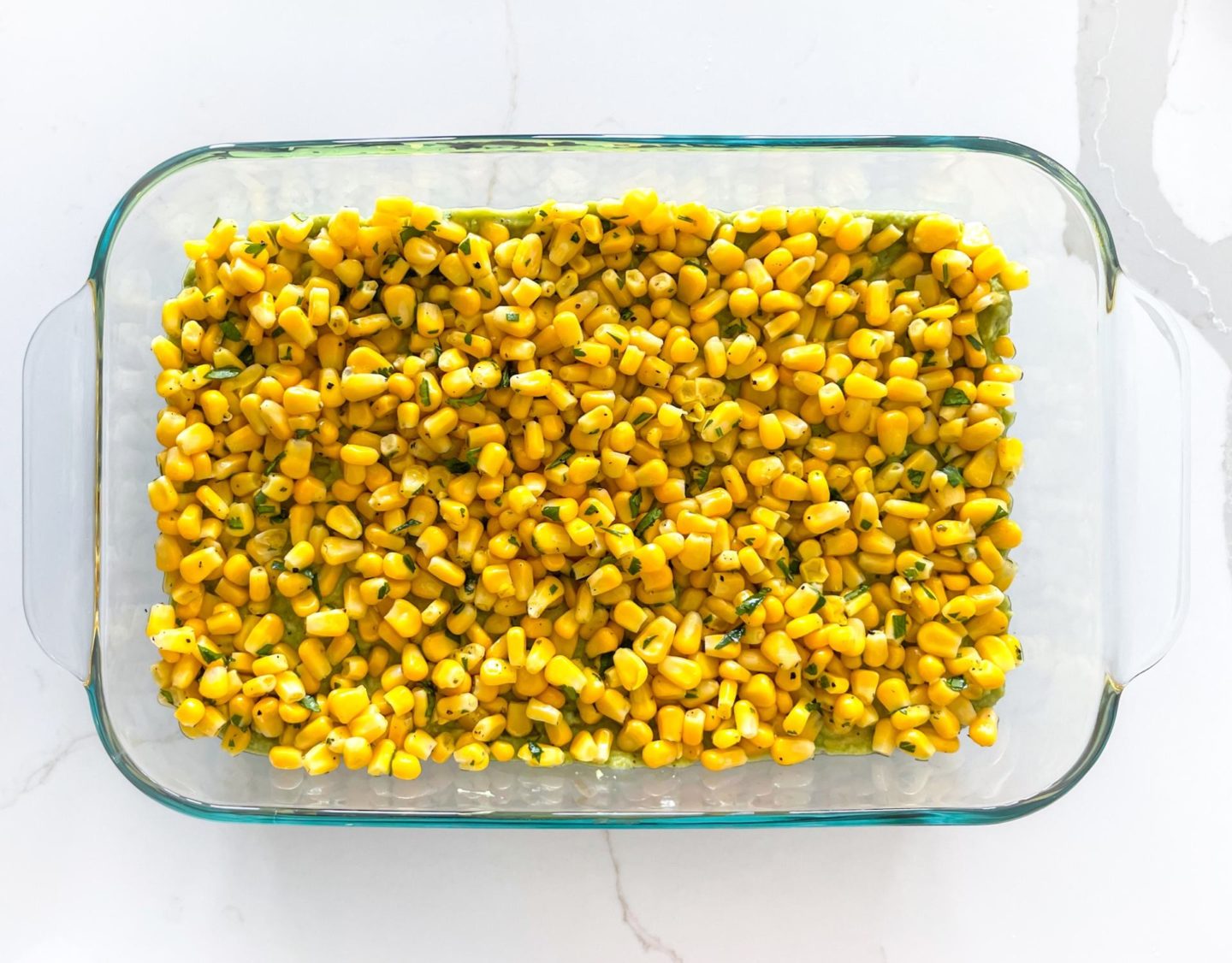 corn in a glass dish on a white counter