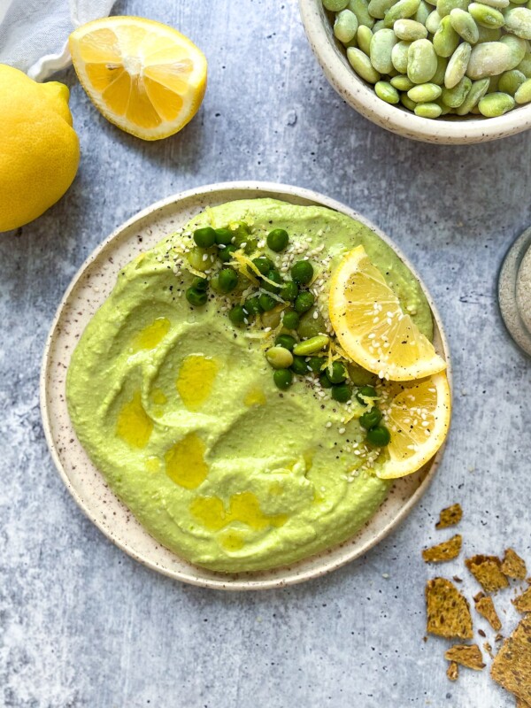 green lima bean hummus on a white plate