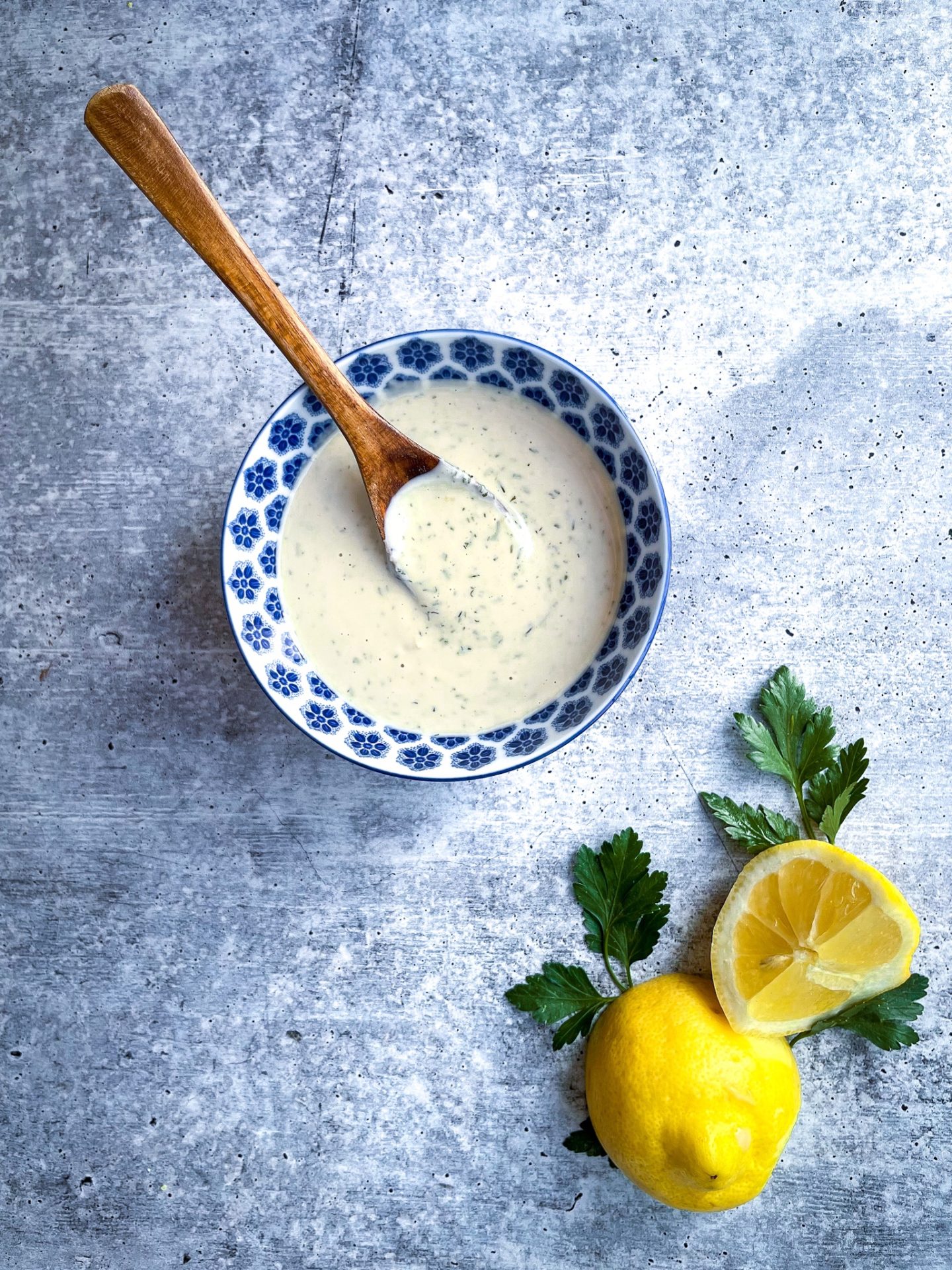 lemon tahini sauce in a blue bowl