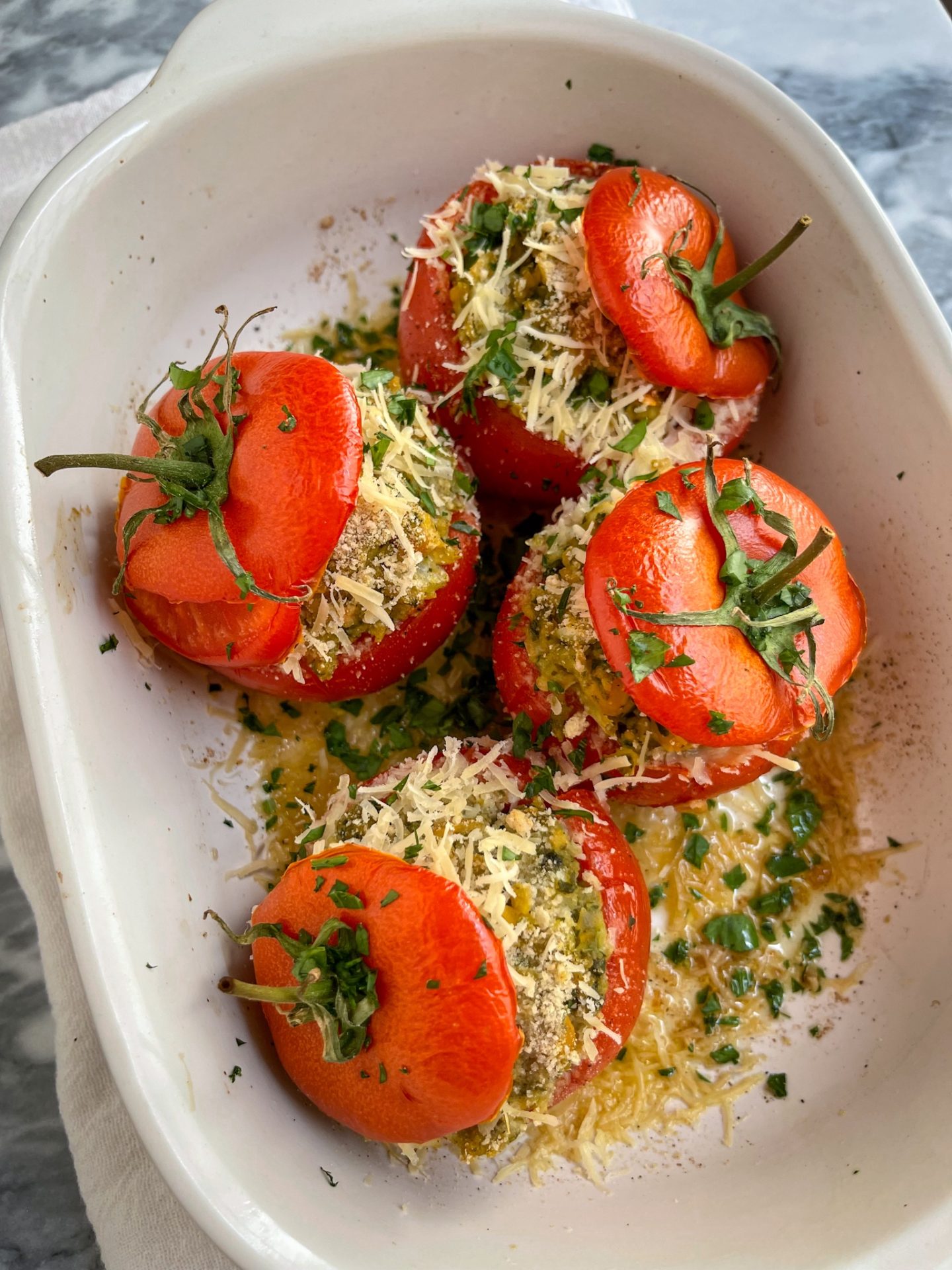 baked tomatoes in a white casserole dish