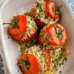 baked tomatoes in a white casserole dish