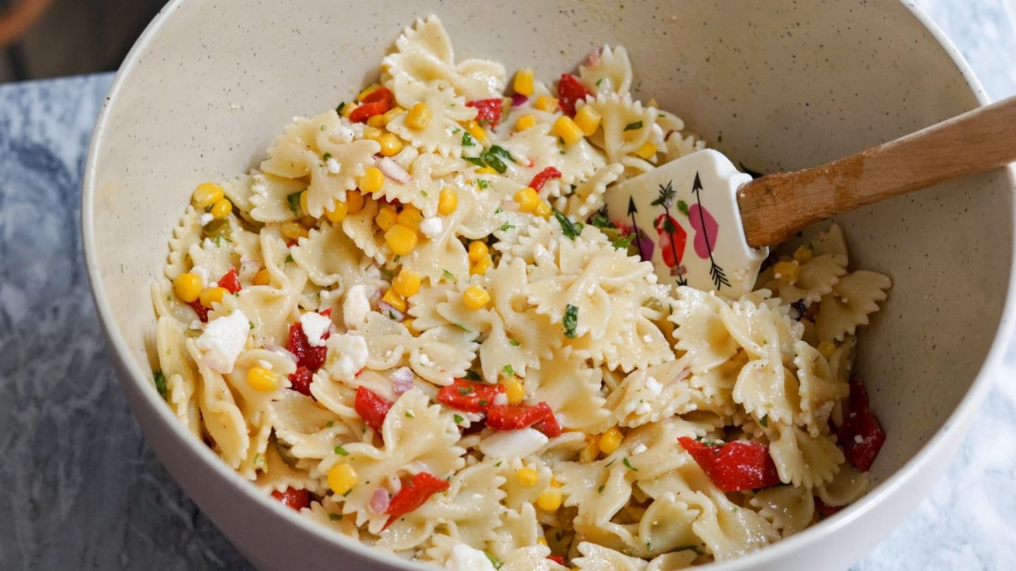 pasta salad in a beige bowl