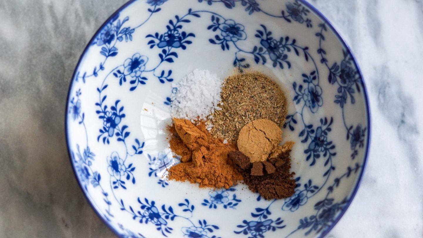 cinnamon, cardamom, allspice and sea salt in a blue bowl