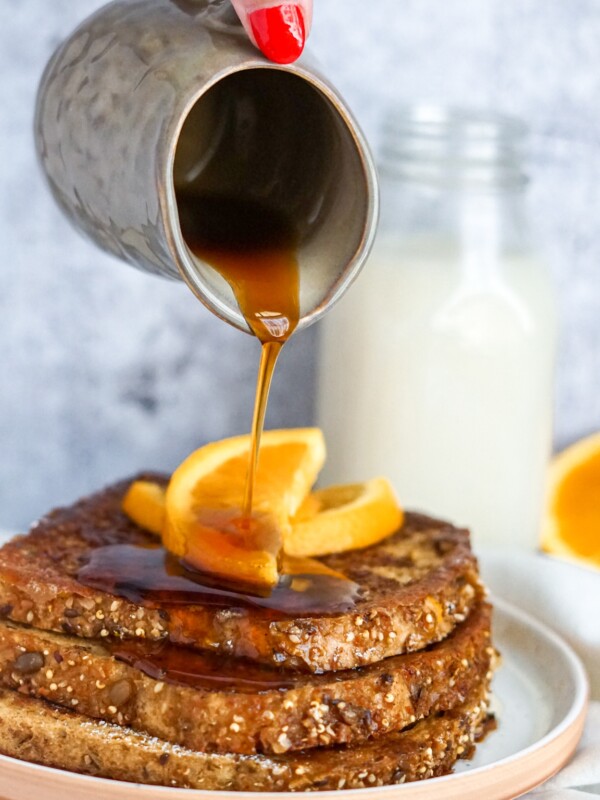 pouring maple syrup on vegan french toast