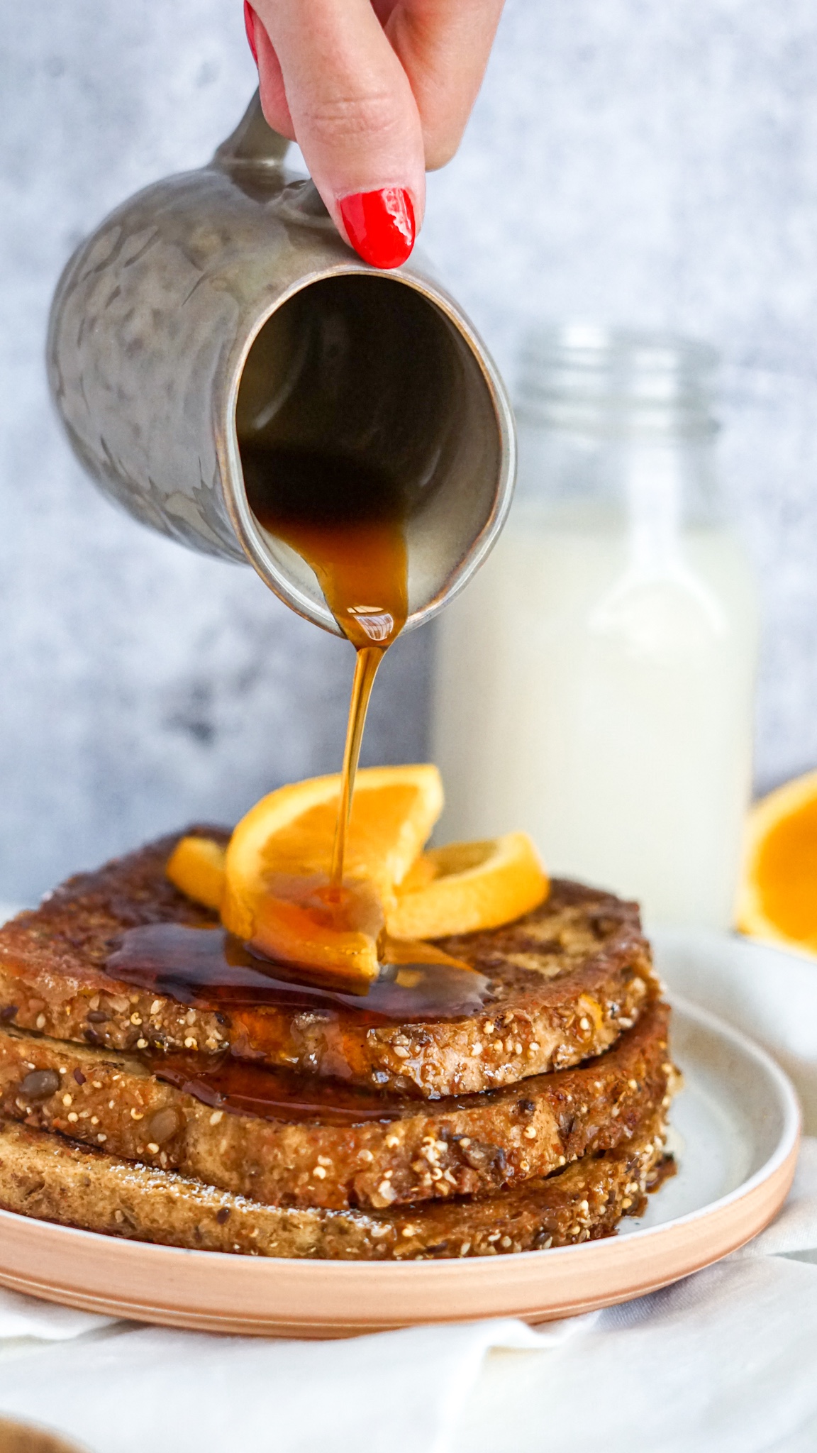 pouring maple syrup on vegan french toast