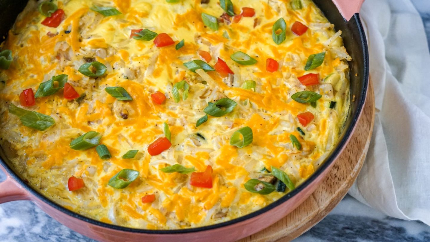 hahsbrowns, vegan eggs and cheese in a skillet