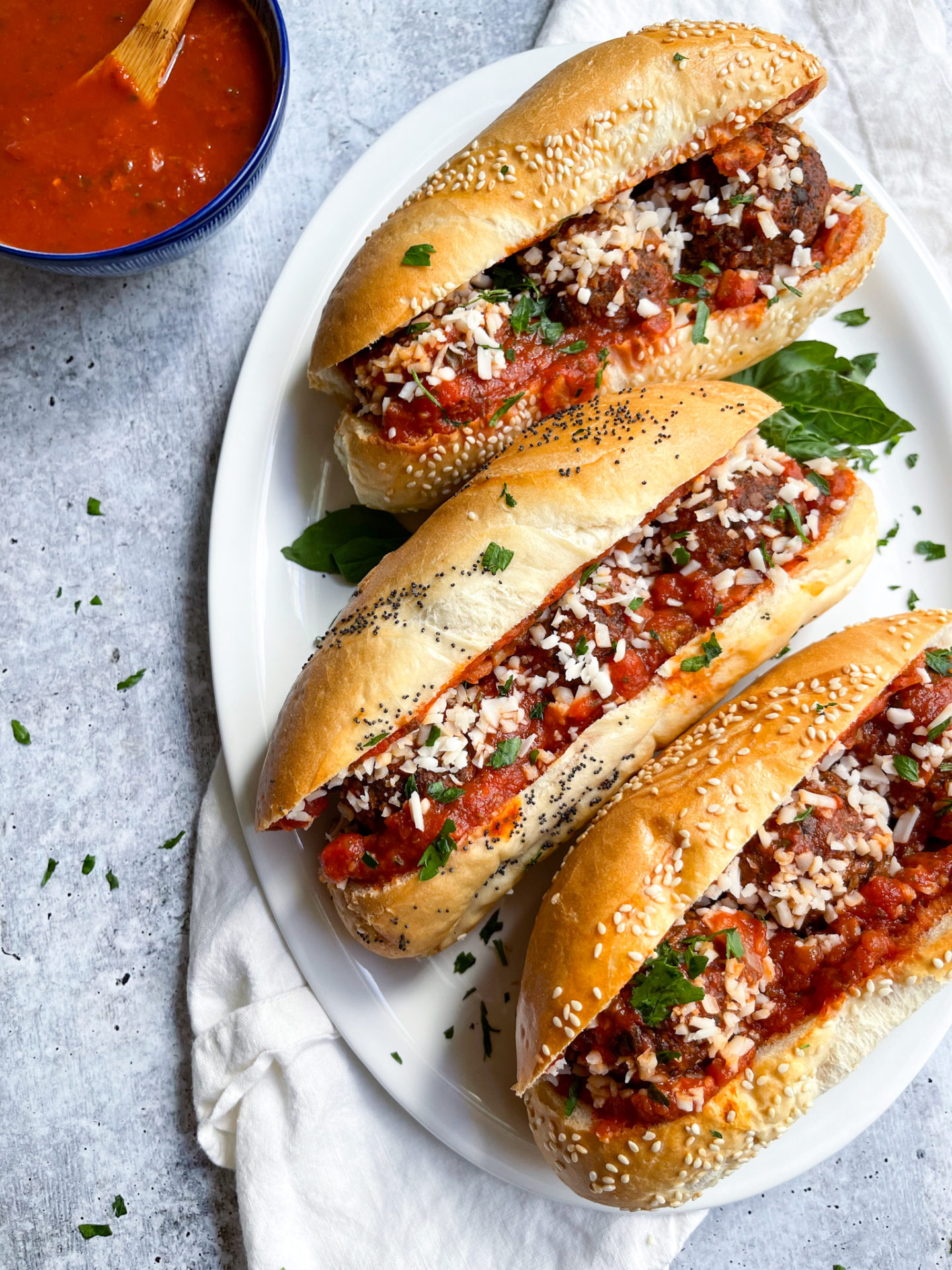 three meatball subs on a white plate