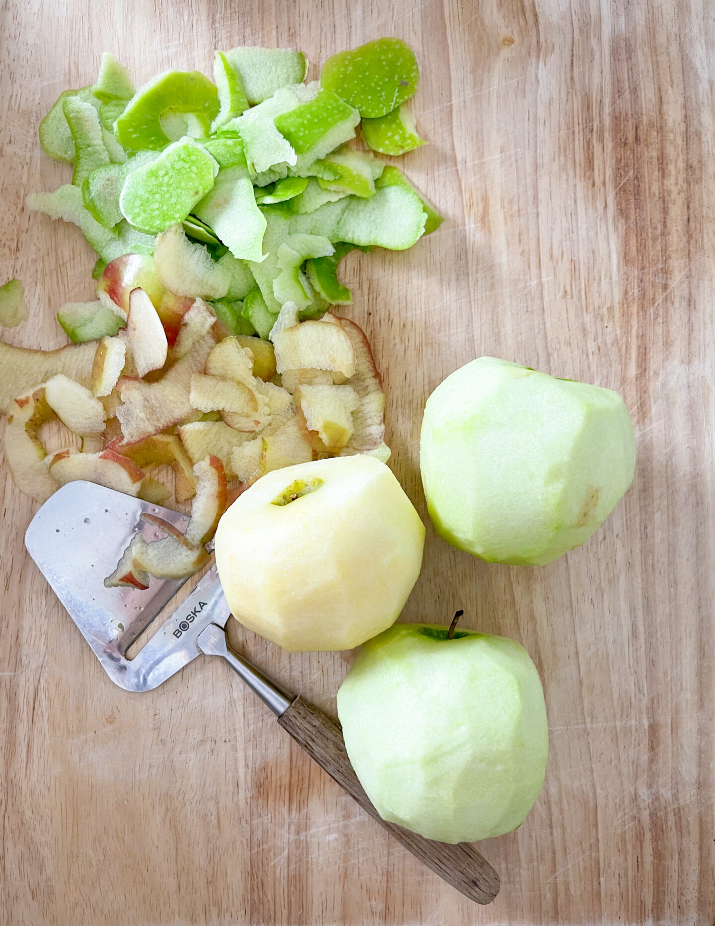 peeled apples on a cutting board 