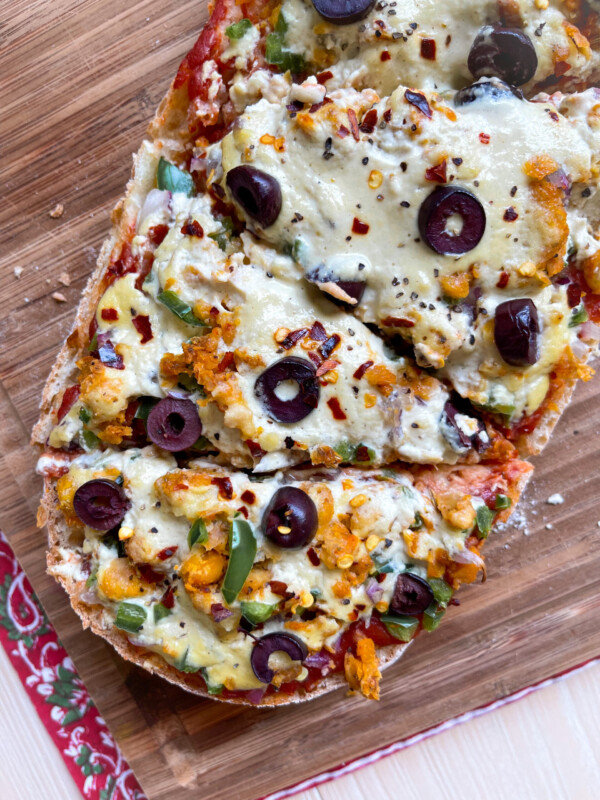 french bread pizza on a wooden cutting board