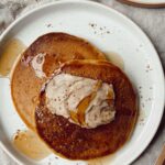 pumpkin pancakes with cinnamon butter on a plate