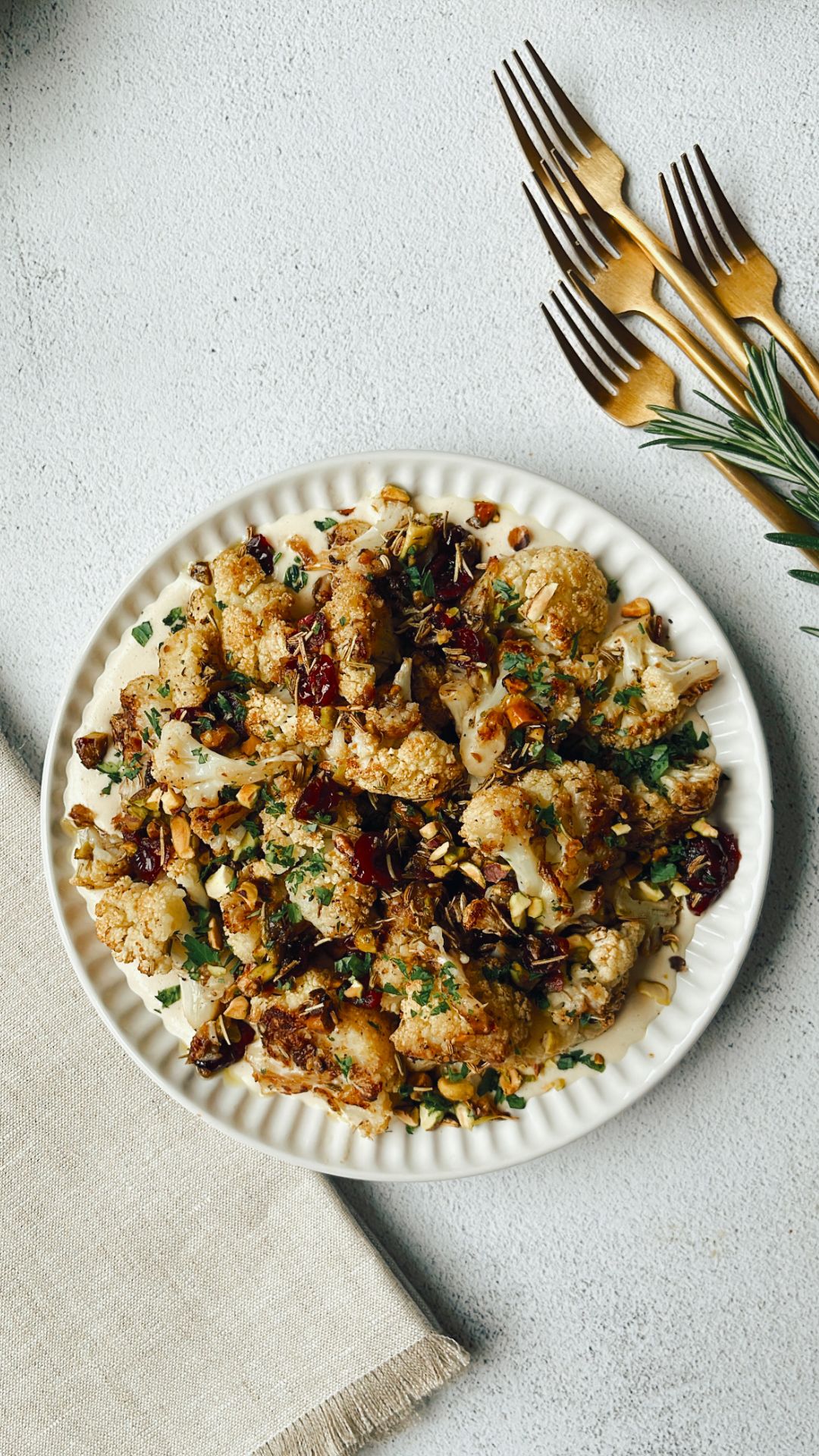 roasted cauliflower with rosemary, pistachios, and cranberries served with dairy-free cashew cream