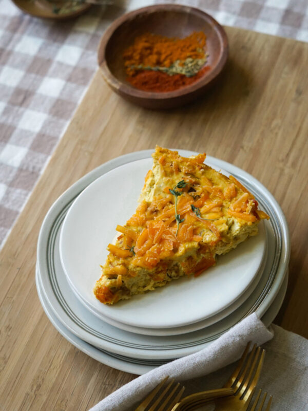 sweet potato frittata sliced and served on a white plate