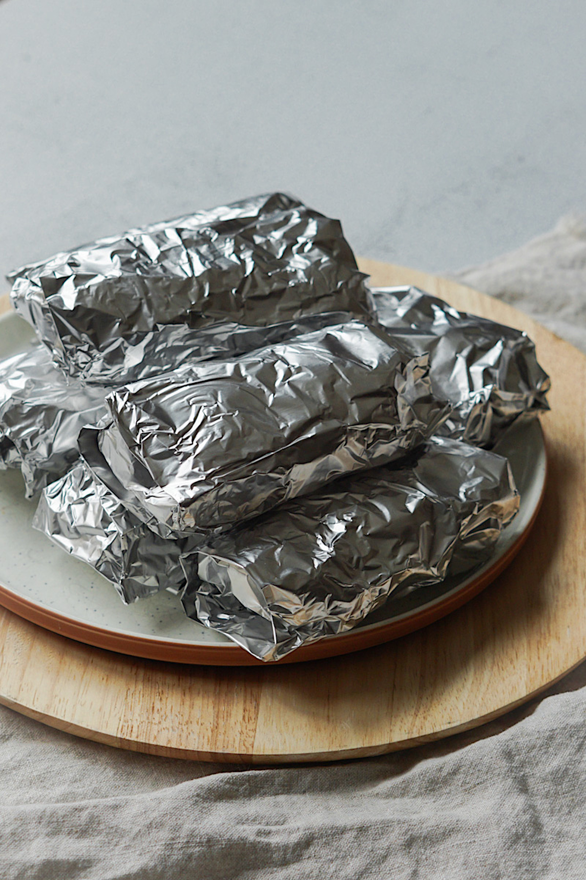 homemade burritos wrapped in foil for the freezer