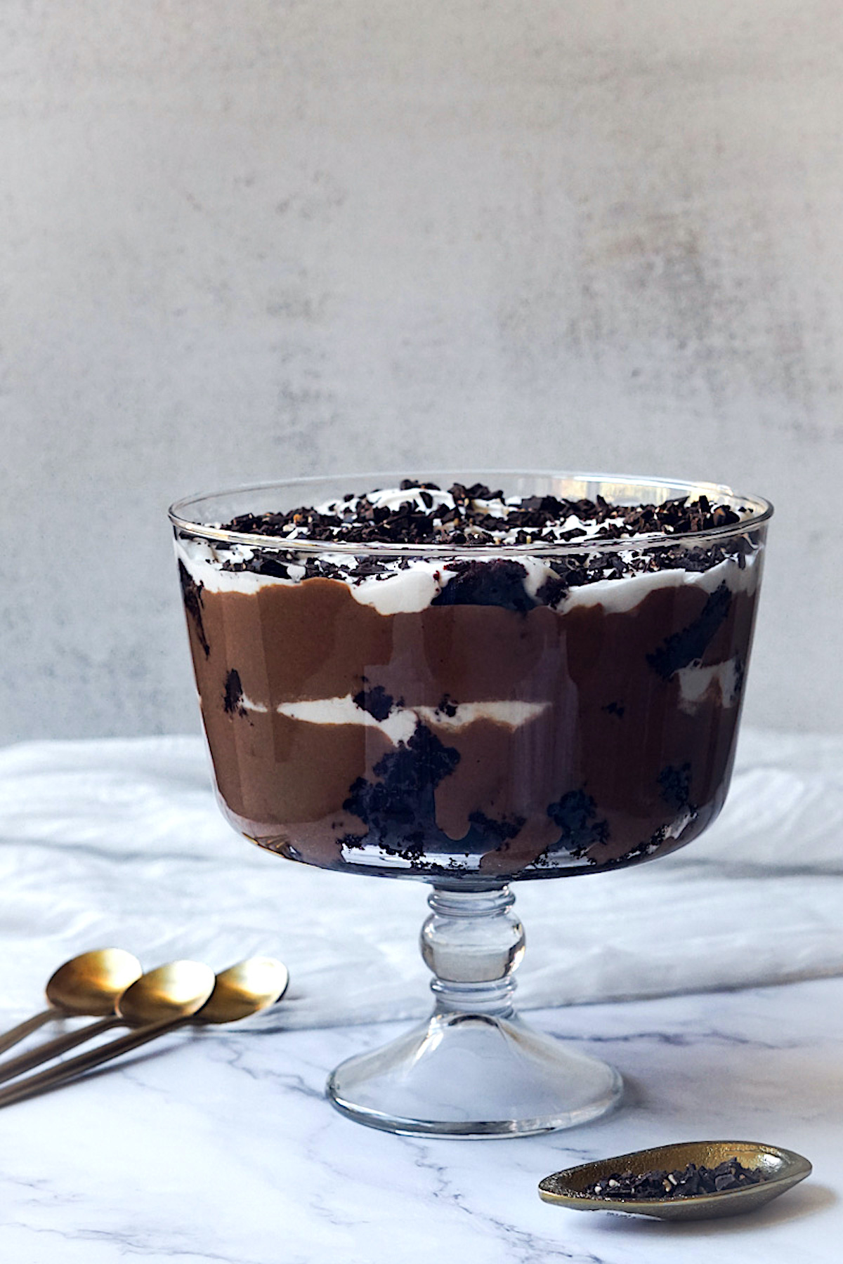 layered chocolate dessert in a glass trifle dish 