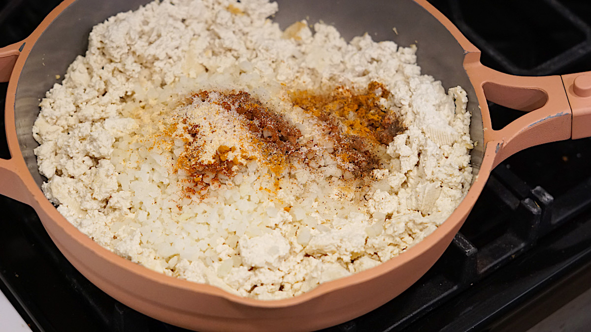 making tofu scramble with spices in a skillet