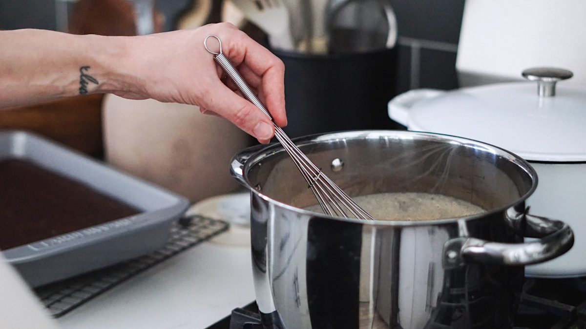 whisking chocolate pudding recipe on the stove