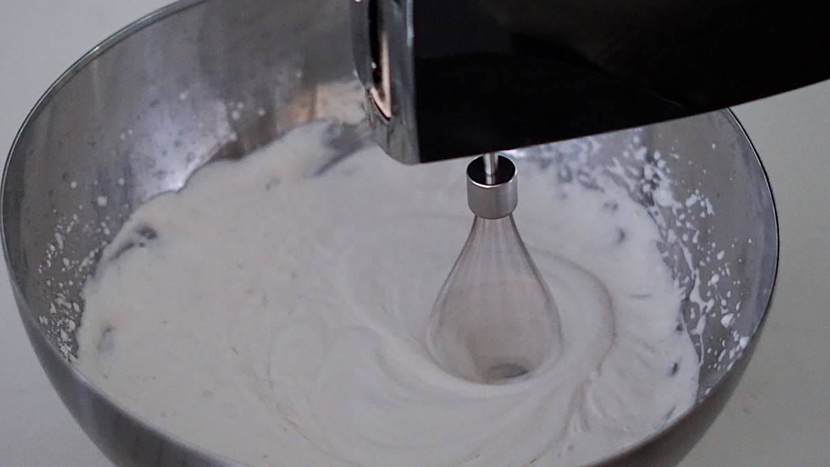 whipping dairy free whipped cream in a large bowl