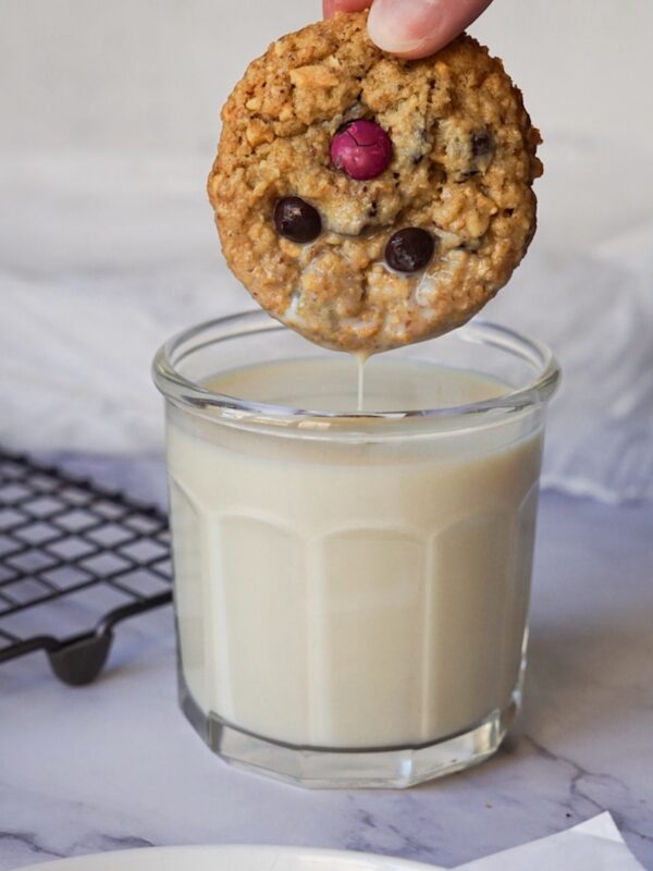 dunking a cookie in a glass of milk