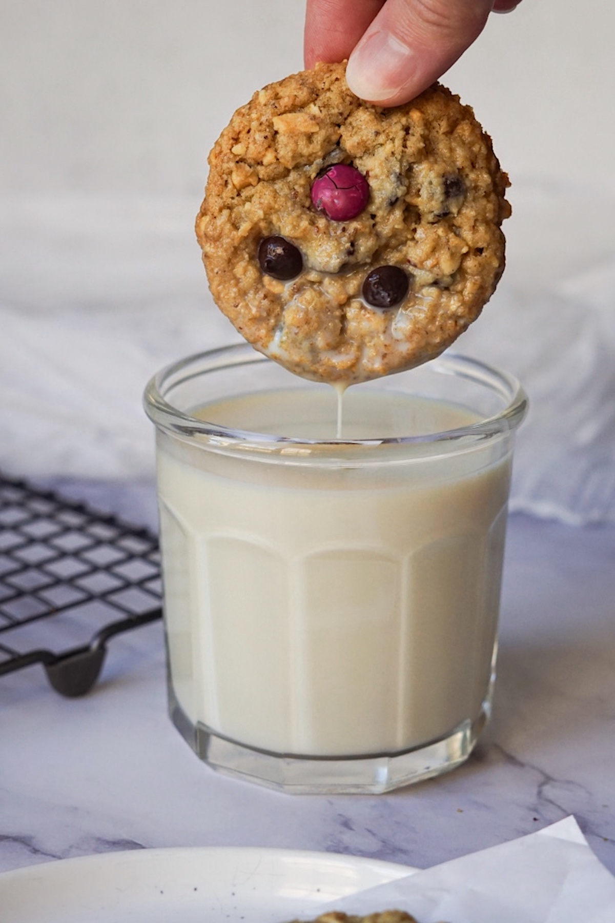 dunking a cookie in a  glass of milk