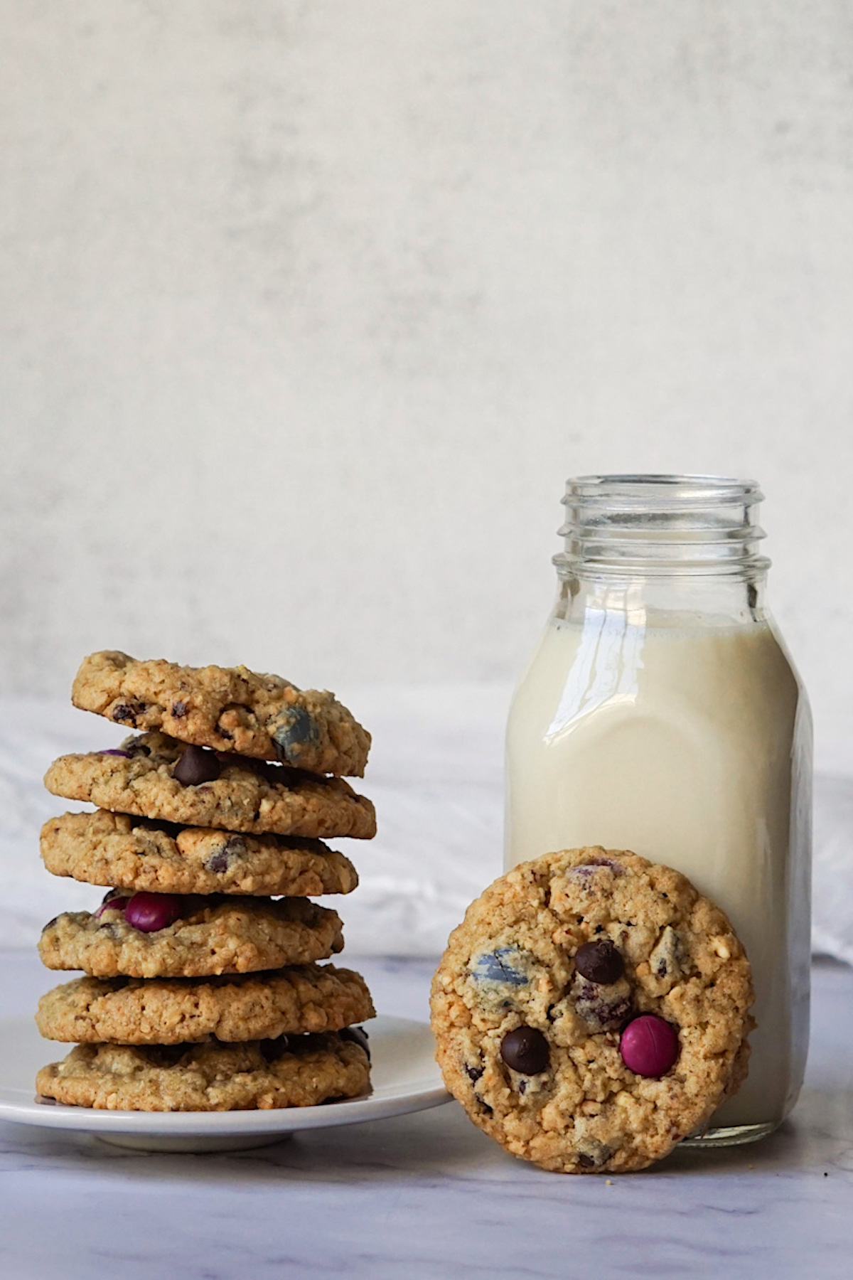 stack of homemade cookies next to a glass of milk