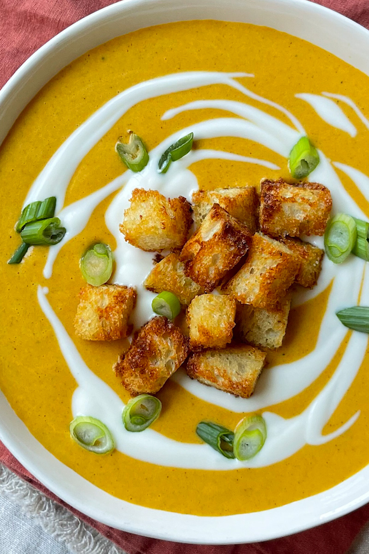 carrot ginger soup with croutons on top